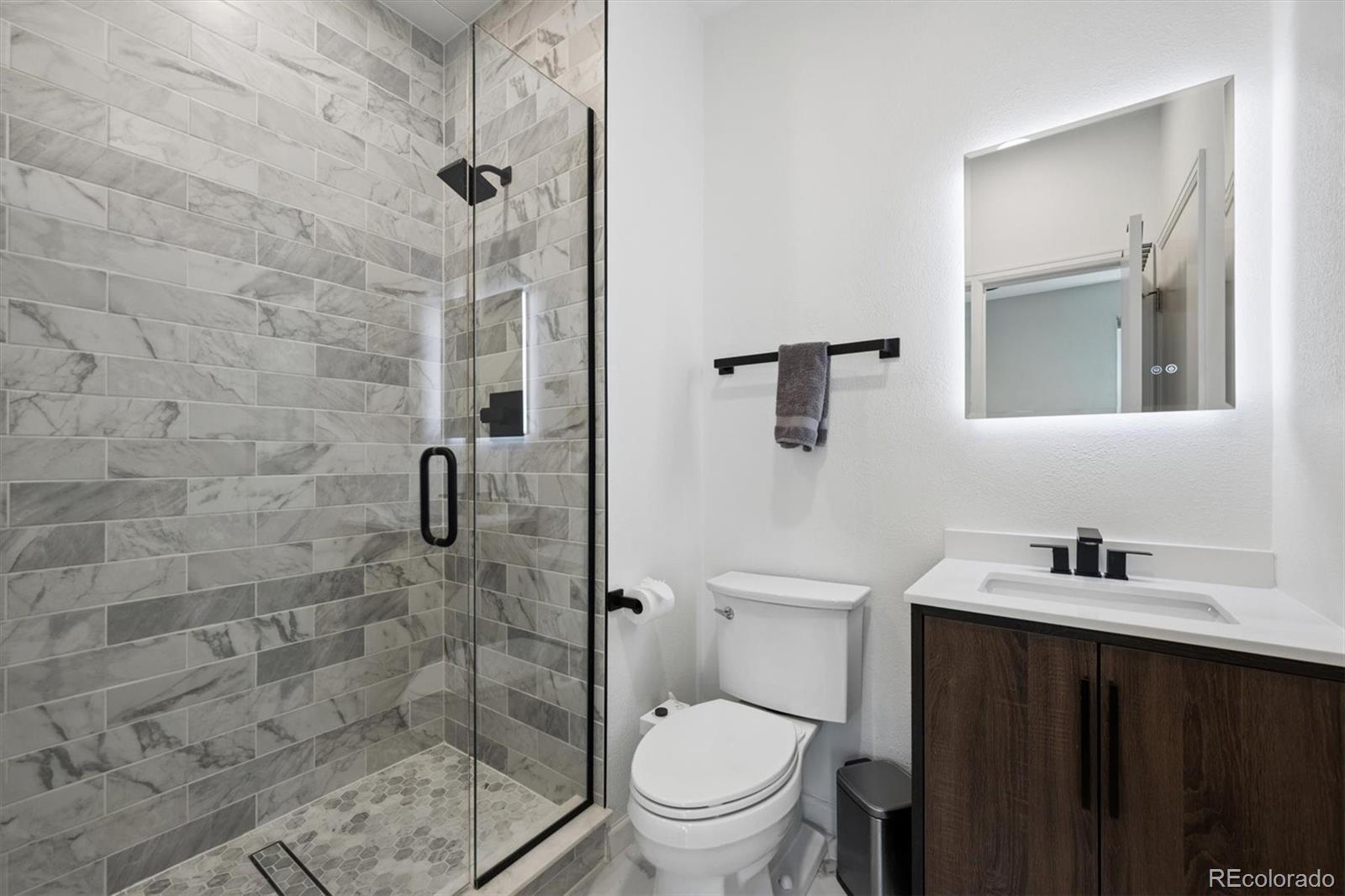 2680 Blake Street, Unit 7 Denver, CO 80205 - Photo 21 of 36 a bathroom with a toilet a sink and shower