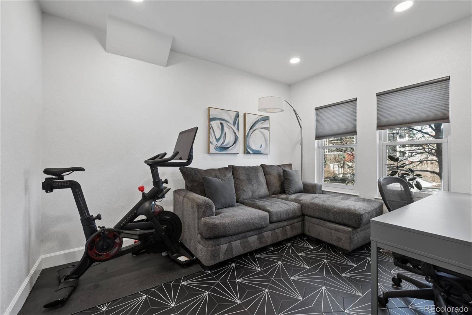2680 Blake Street, Unit 7 Denver, CO 80205 - Photo 23 of 36 a living room with furniture a rug and white walls
