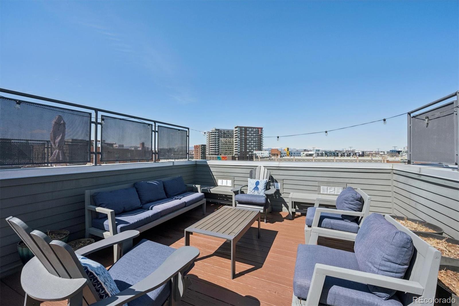 2680 Blake Street, Unit 7 Denver, CO 80205 - Photo 26 of 36 a roof deck with a couch and chairs