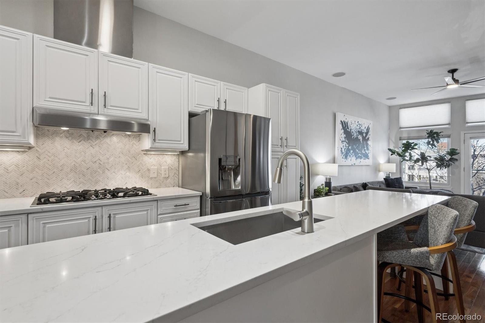2680 Blake Street, Unit 7 Denver, CO 80205 - Photo 7 of 36 a kitchen with stainless steel appliances a sink a stove and a refrigerator