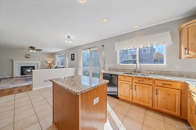 a kitchen with granite countertop sink and cabinets