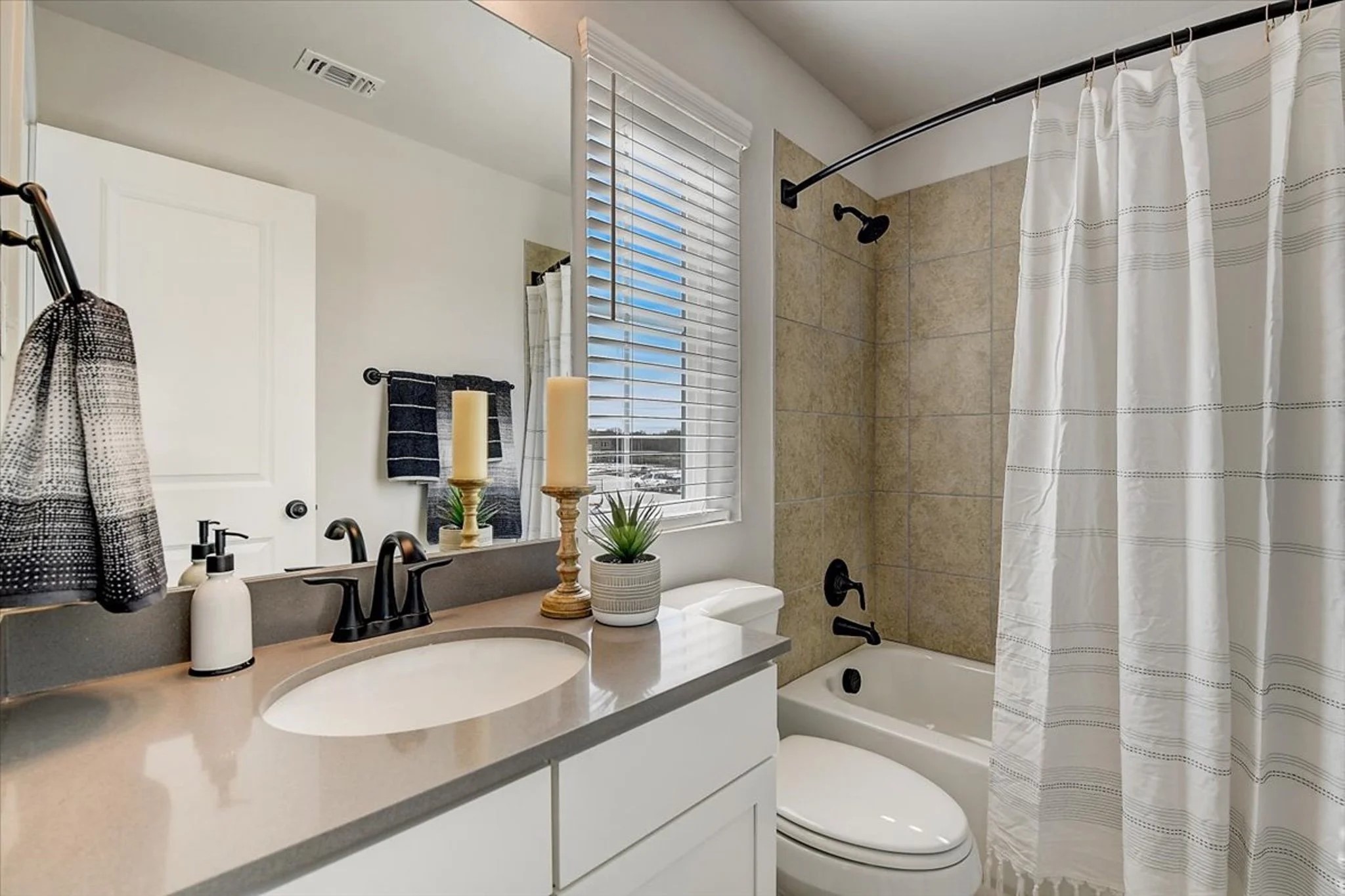 15101 Litsey Crk Drive, Unit 14726R Roanoke, TX 76262 - Photo 16 of 21 a bathroom with a double vanity sink toilet mirror and shower