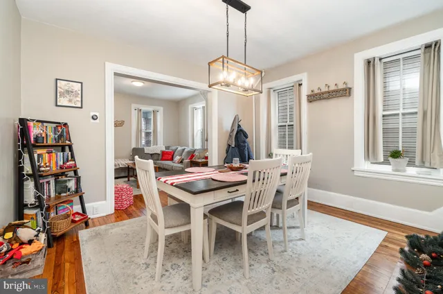 a view of a dining room with furniture and a chandelier