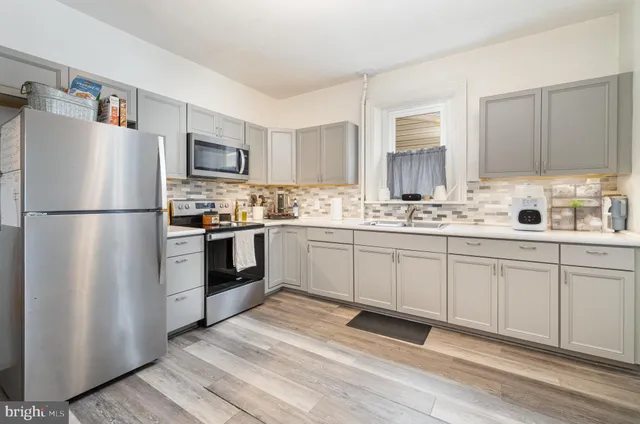 a kitchen with a refrigerator stove and sink
