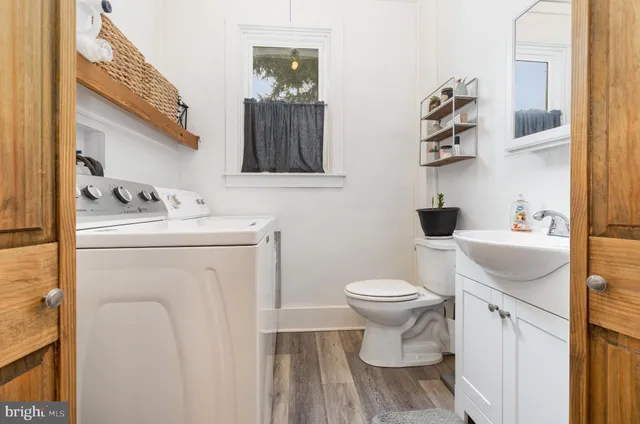 a bathroom with a sink toilet and a mirror