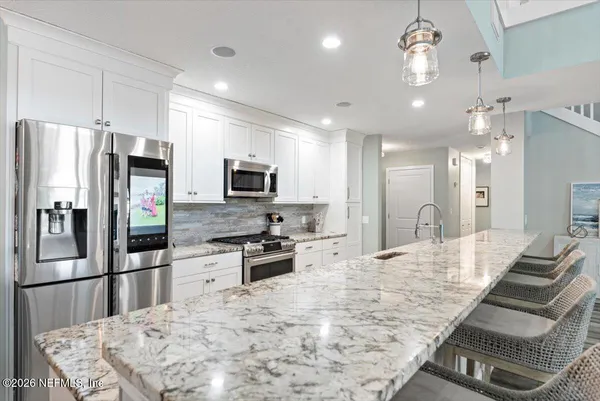 a living room with furniture a wooden floor and a large window