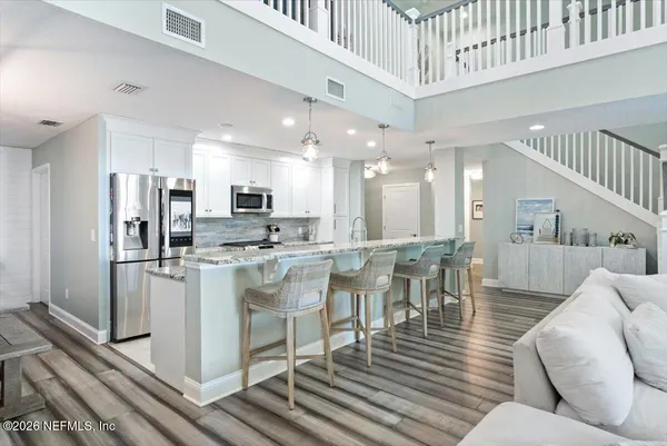 a kitchen with granite countertop a wooden cabinets and window