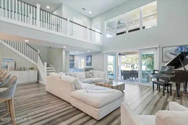 a spacious bedroom with a bed and a flat screen tv