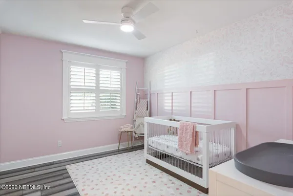 a view of a hallway with wooden floor and stairs