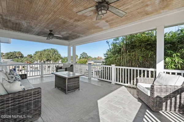 a view of a house with backyard porch and sitting area