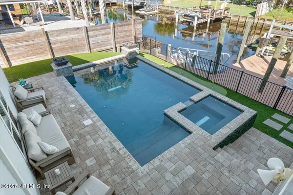 a view of a house with a backyard and a patio