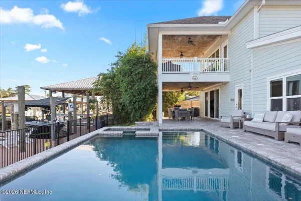 a view of a swimming pool with outdoor seating