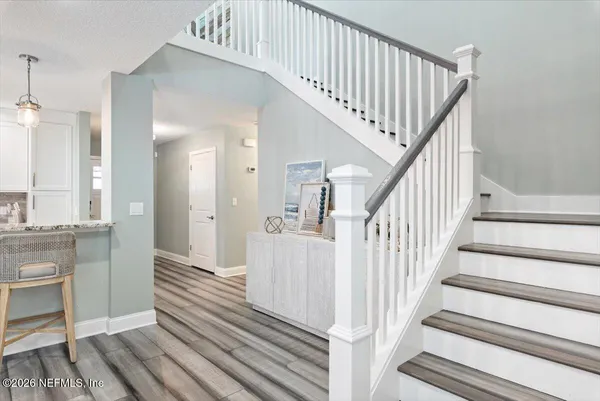 a bathroom with a granite countertop sink and a large mirror