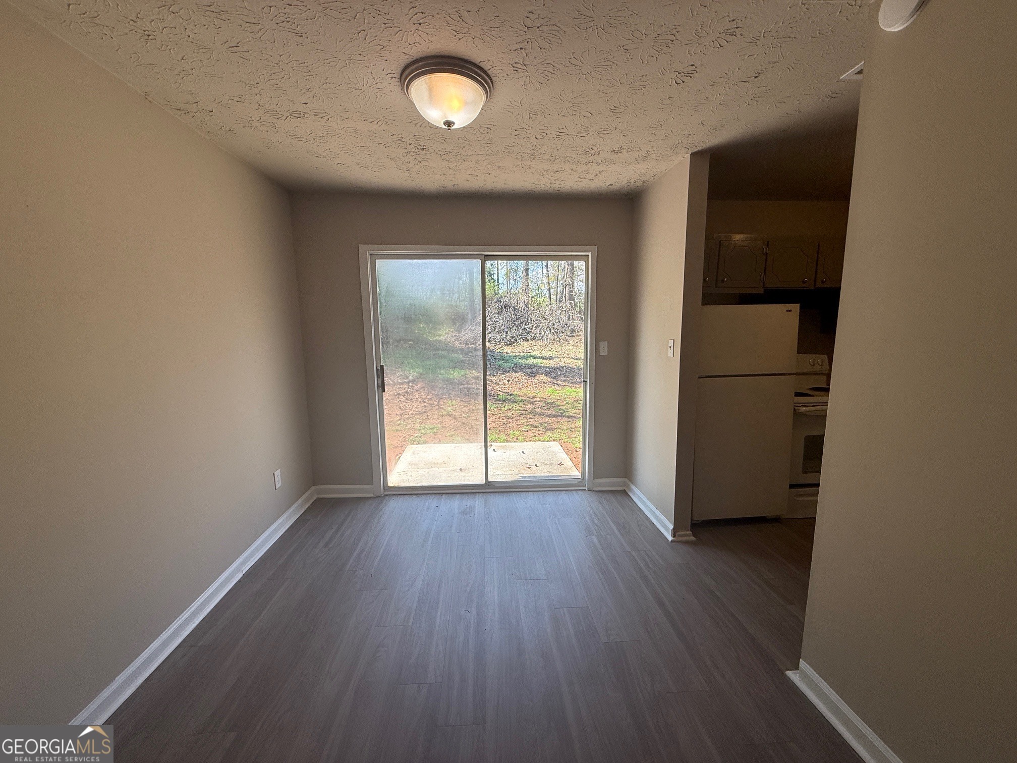 255 Rustwood Drive Athens, GA 30606 - Photo 4 of 9 an empty room with wooden floor and windows