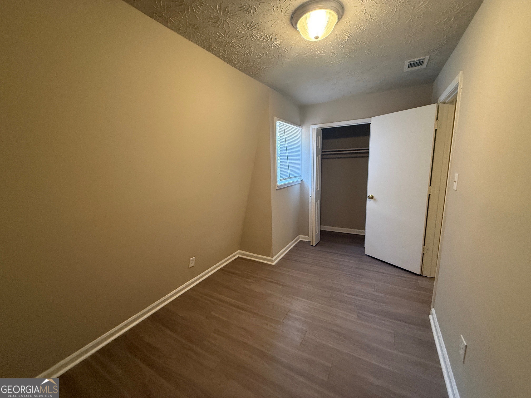 255 Rustwood Drive Athens, GA 30606 - Photo 6 of 9 an empty room with wooden floor and windows