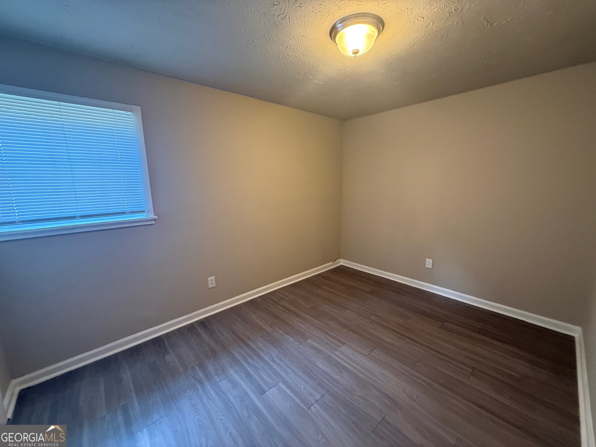 255 Rustwood Drive Athens, GA 30606 - Photo 7 of 9 a view of an empty room with wooden floor and a window