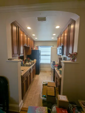 a kitchen with a sink appliances and cabinets