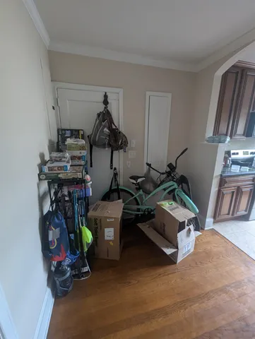 a room with gym equipment and wooden floor