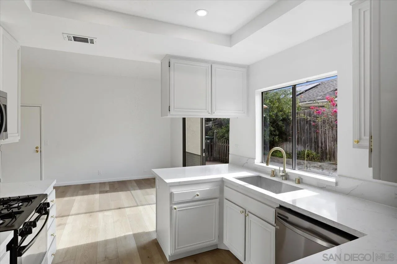 1708 Woodbridge Road Escondido, CA 92026 - Photo 12 of 38 a kitchen with a sink and refrigerator
