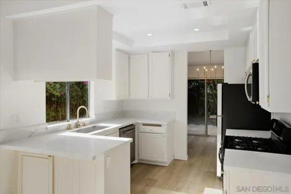 a kitchen with a sink and a refrigerator