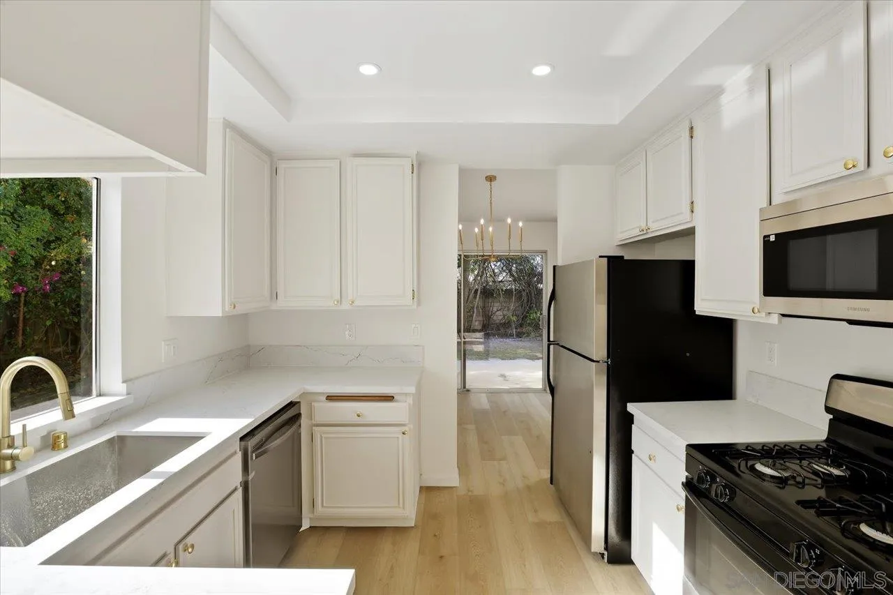 1708 Woodbridge Road Escondido, CA 92026 - Photo 14 of 38 a kitchen with a sink appliances and cabinets