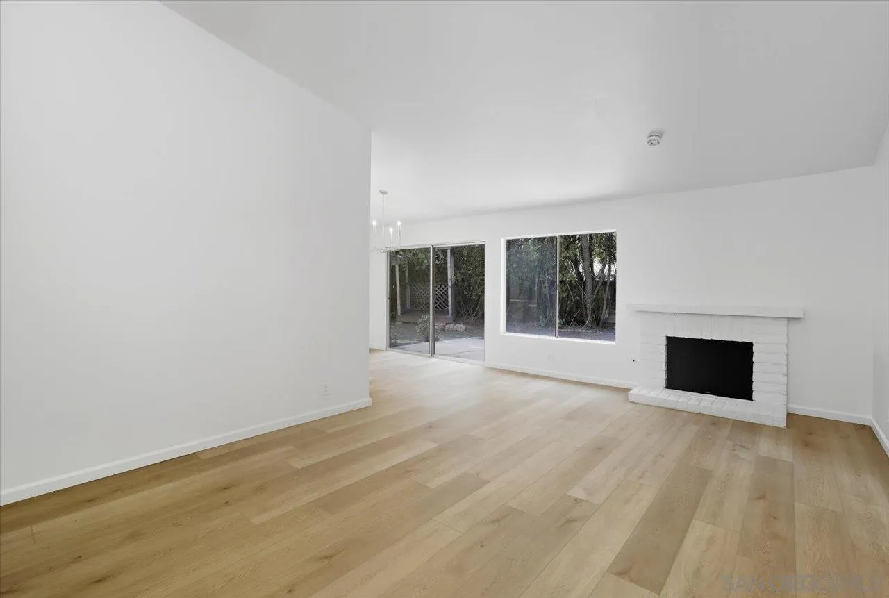1708 Woodbridge Road Escondido, CA 92026 - Photo 15 of 38 a view of an empty room with wooden floor and a window