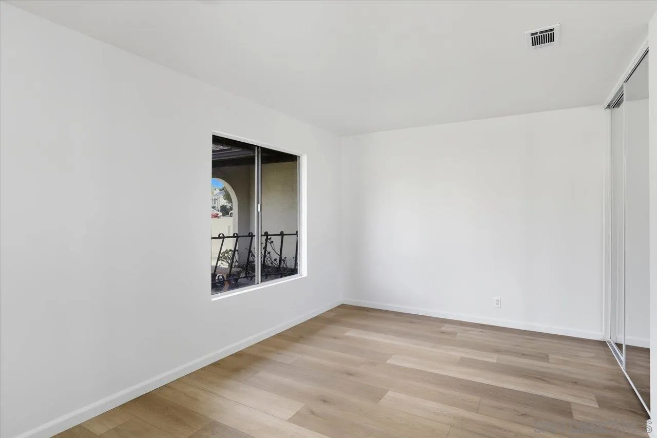 1708 Woodbridge Road Escondido, CA 92026 - Photo 29 of 38 an empty room with wooden floor and windows