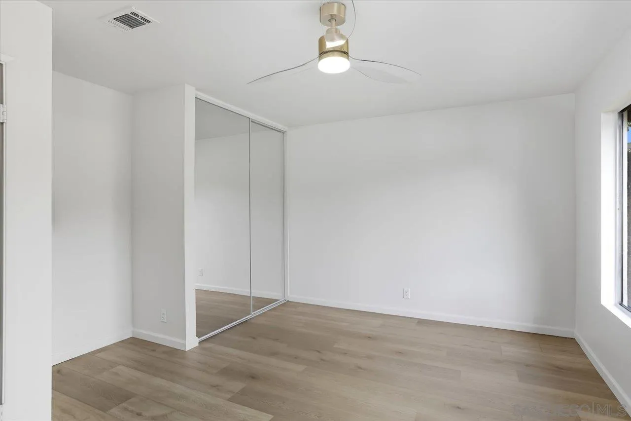 1708 Woodbridge Road Escondido, CA 92026 - Photo 31 of 38 an empty room with a ceiling fan and window