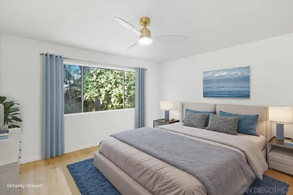 a bedroom with a large bed and a window