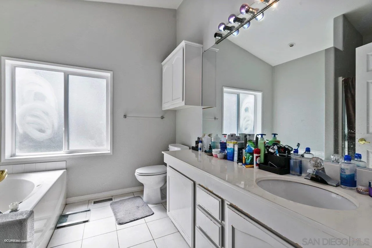 8622 Gardena Road Lakeside, CA 92040 - Photo 23 of 29 a bathroom with a sink mirror and toilet