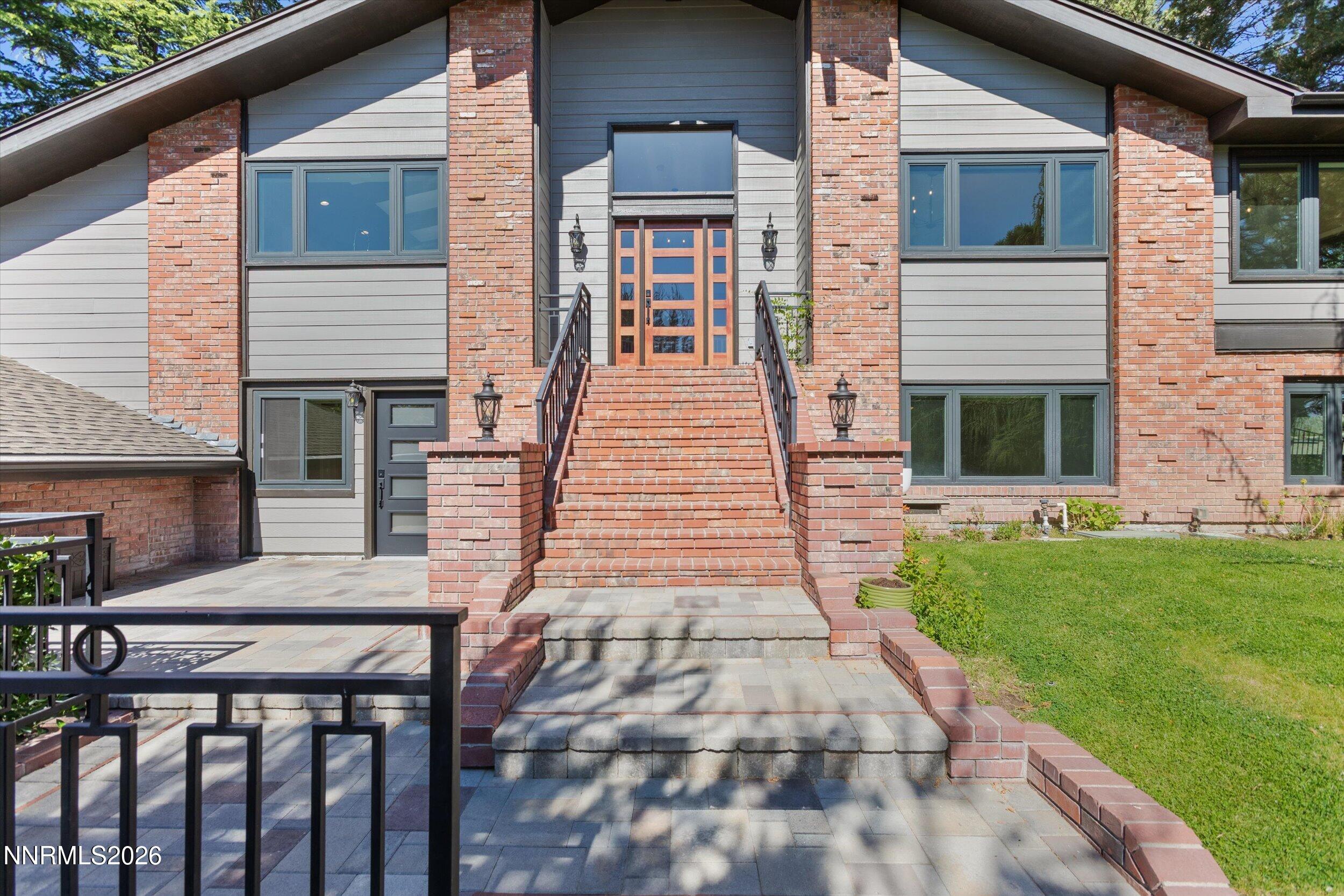 2725 West Lake Ridge Shores Reno, NV 89519 - Photo 2 of 49 a front view of a house with garden