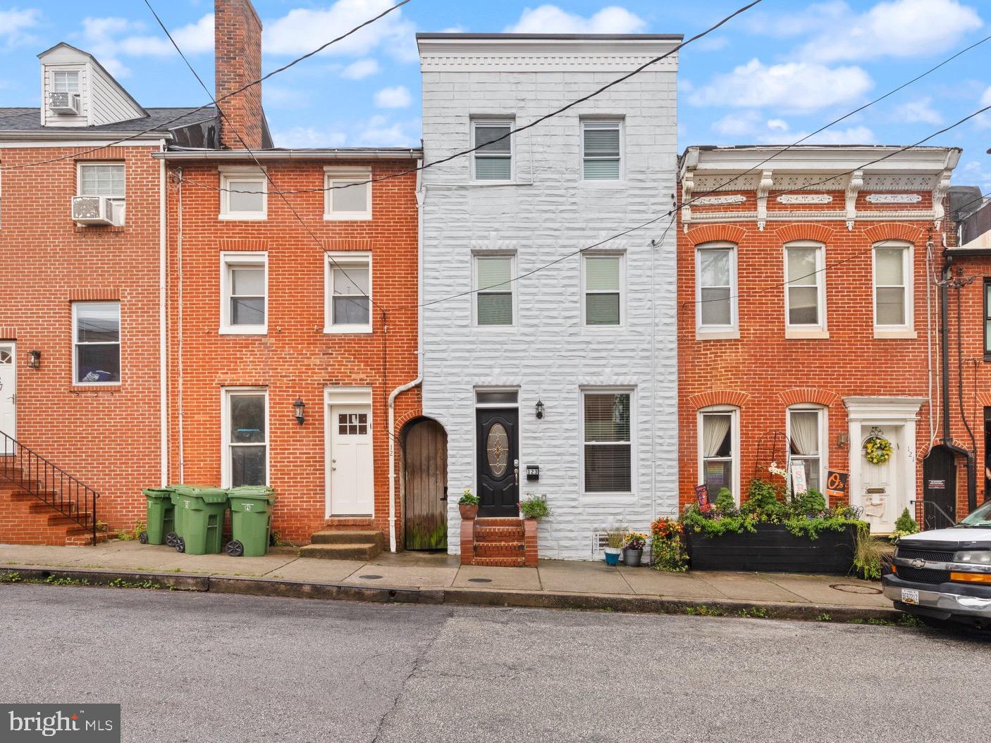123 East Cross Street Baltimore, MD 21230 - Photo 1 of 33 front view of a brick house with a yard