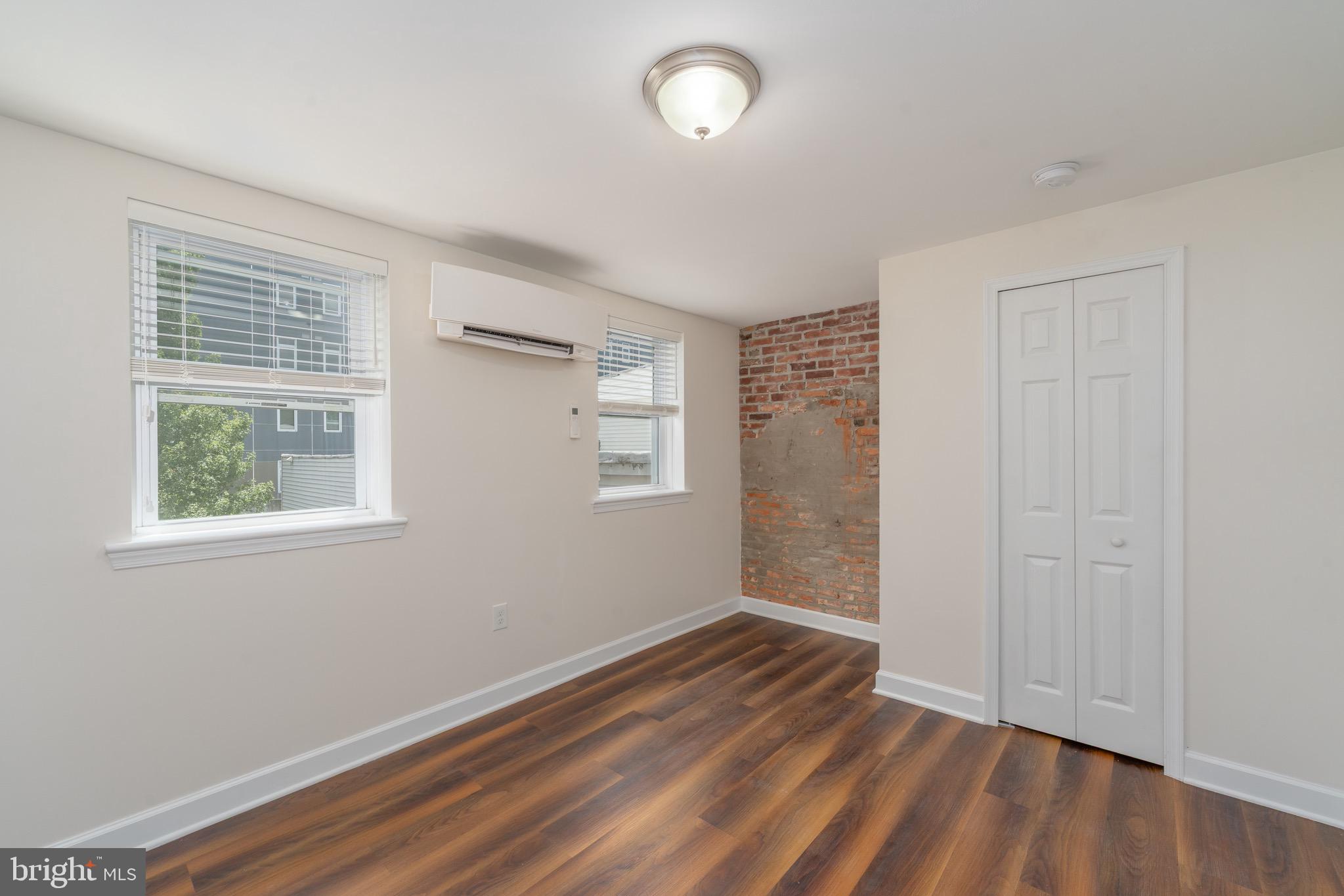 123 East Cross Street Baltimore, MD 21230 - Photo 19 of 33 an empty room with wooden floor and windows