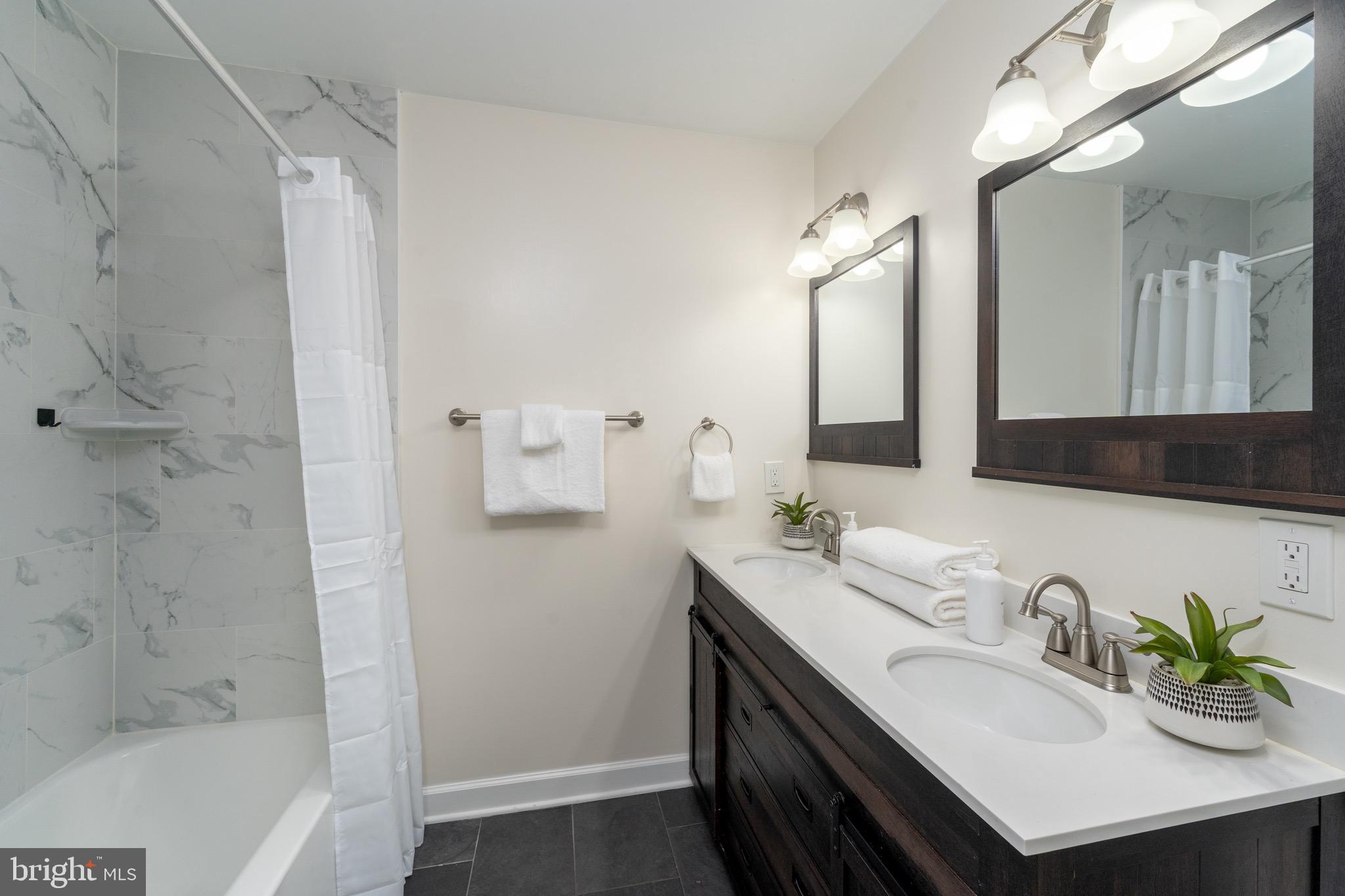 123 East Cross Street Baltimore, MD 21230 - Photo 20 of 33 a bathroom with a sink double vanity and a bathtub