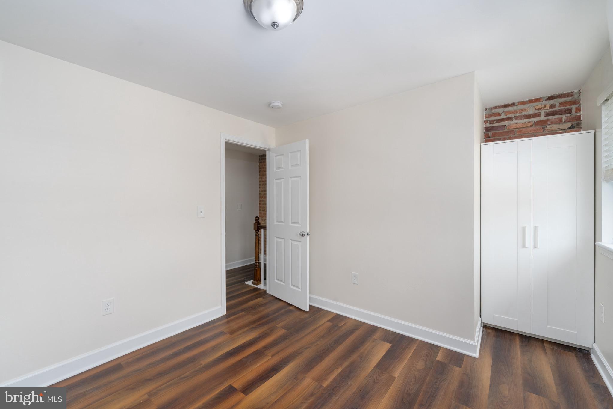 123 East Cross Street Baltimore, MD 21230 - Photo 27 of 33 a view of an empty room with wooden floor