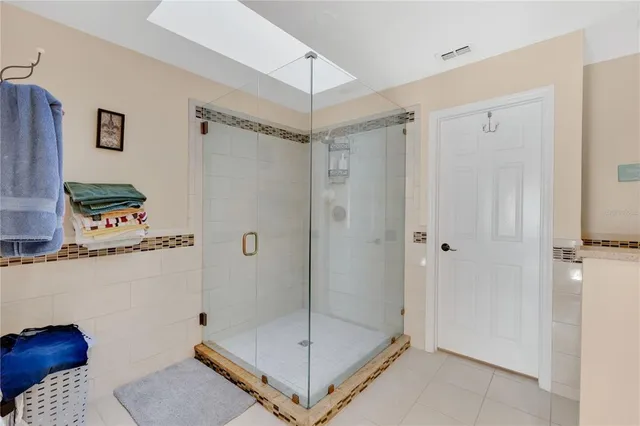 a bathroom with a shower and a sink