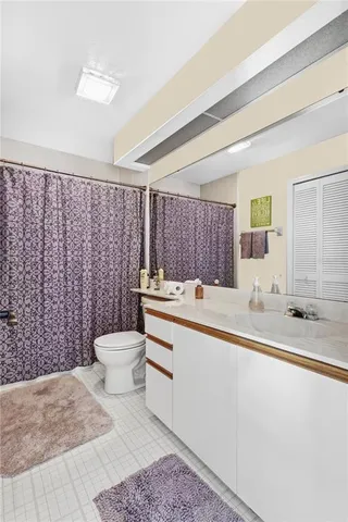 a bathroom with a sink a toilet and mirror