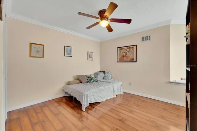 a living room with couch and a ceiling fan