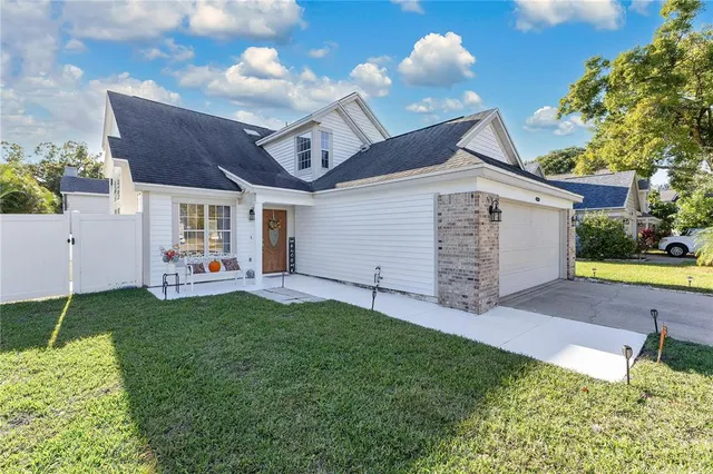 a backyard of a house with table and chairs