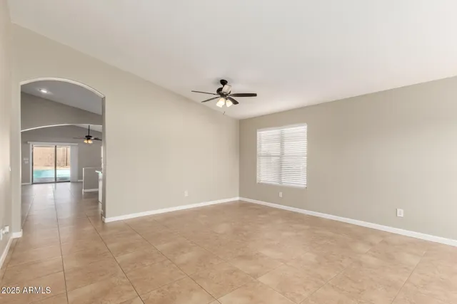 a view of a livingroom with a ceiling fan and window