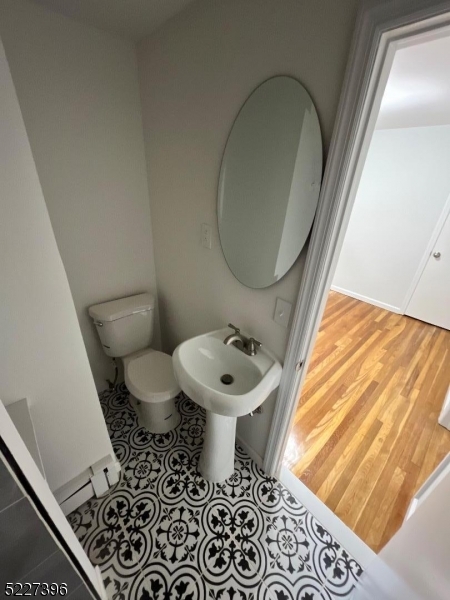 434 Richmond Street Elizabeth, NJ 07202 - Photo 5 of 5 a bathroom with a sink toilet and a mirror