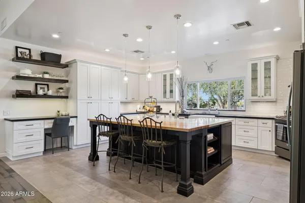 a kitchen with stainless steel appliances granite countertop a stove and a refrigerator