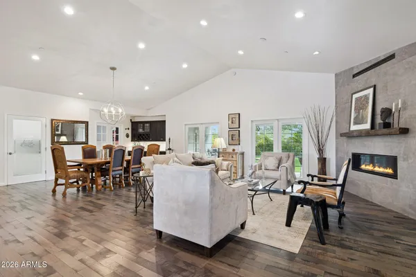 a living room with fireplace furniture and a wooden floor