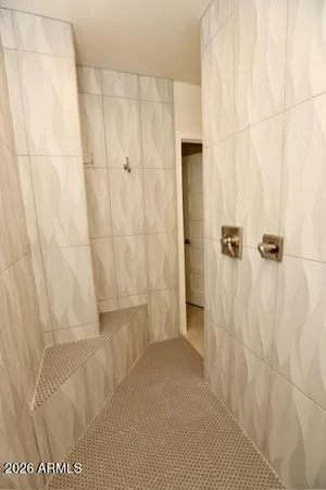 a kitchen with granite countertop a table chairs sink and microwave