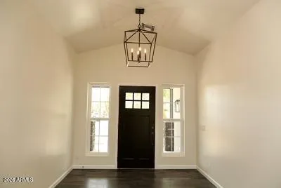 a view of a livingroom with wooden floor and a fireplace