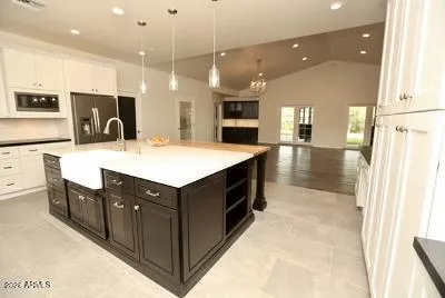 a view of kitchen with stainless steel appliances granite countertop stove top oven and refrigerator