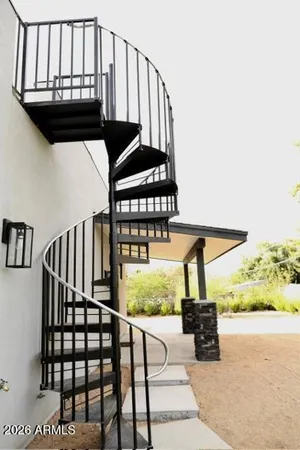 a bathroom with a granite countertop sink a mirror and shower