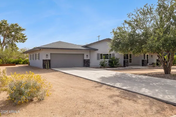 a front view of a house with a garden