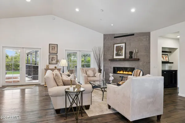 a kitchen with stainless steel appliances granite countertop a table chairs sink refrigerator and cabinets