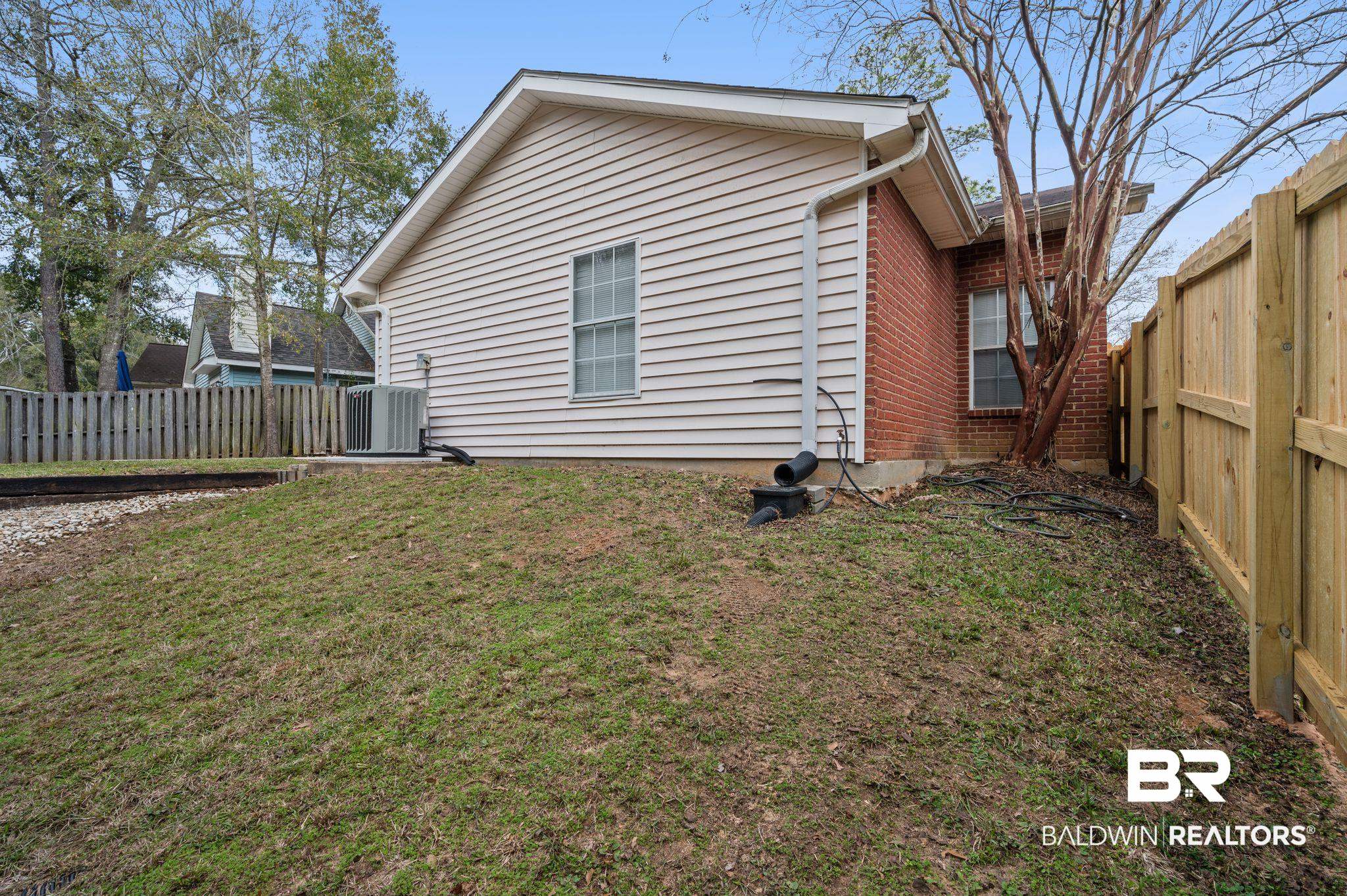 3716 Pepper Ridge Drive Mobile, AL 36693 - Photo 18 of 20 Back of house with a yard and cooling unit